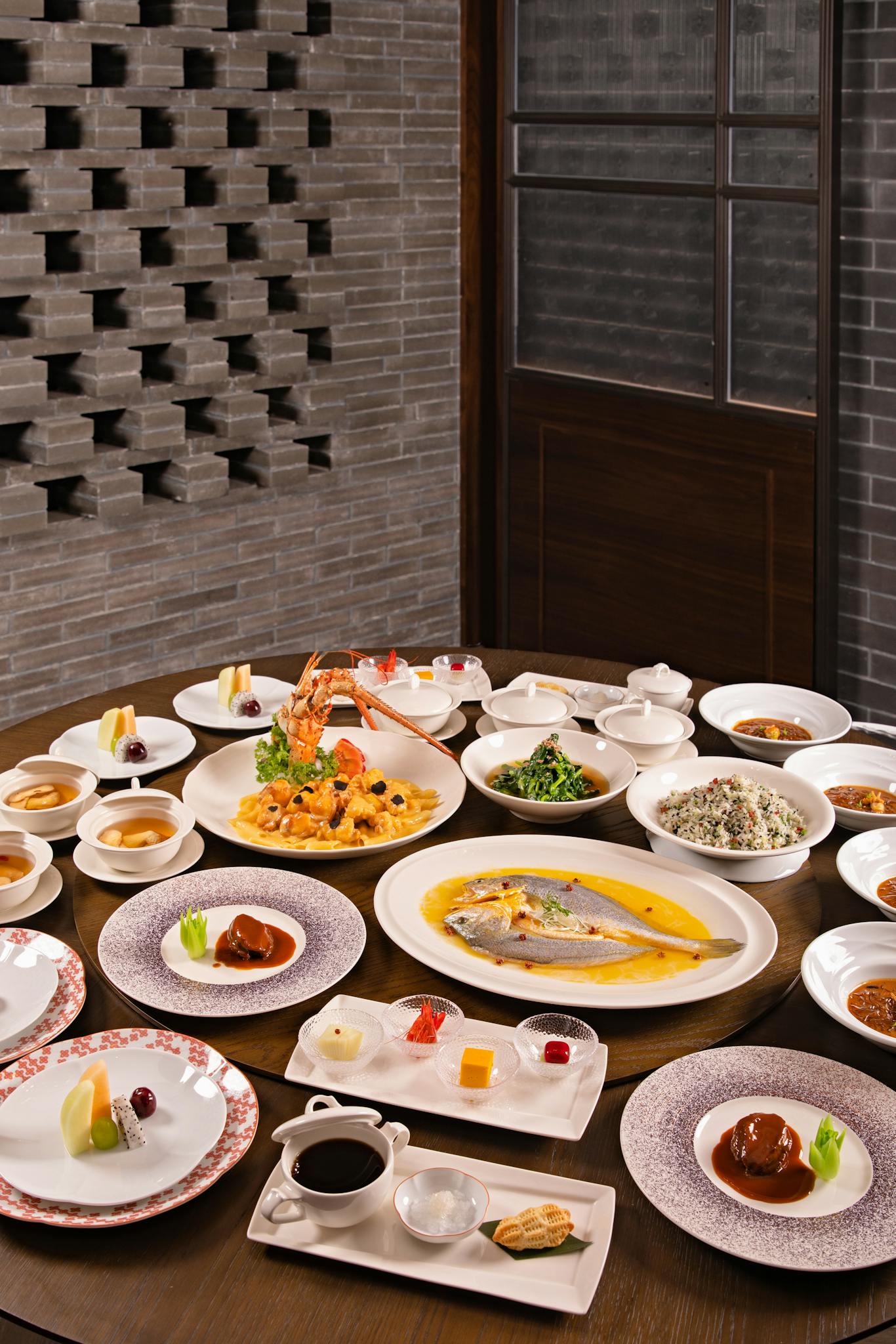 A lavish Chinese banquet featuring a wide array of traditional dishes elegantly arranged on a large round table.